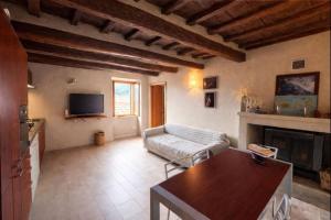 a living room with a couch and a fireplace at Borgo Agapito in Marciana