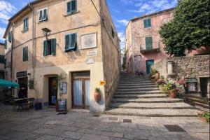 an alley in an old town with stone buildings at Borgo Agapito in Marciana