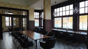 a conference room with a wooden table and chairs at Karmeliterhof Studios & Suites in Boppard