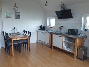 a kitchen with a wooden table and a dining room at Anna's Bêd & Brochje en vakantieverblijf in Donkerbroek