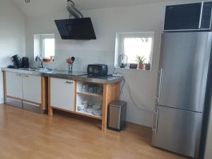 a kitchen with a stainless steel refrigerator and a counter at Anna's Bêd & Brochje en vakantieverblijf in Donkerbroek +16 photos