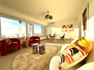 a living room with a couch and a large window at Casa Cielo-Spectacular View-Center-Chic-Spacious in Liège