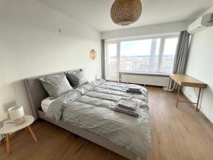 a bedroom with a bed and a desk and a window at Casa Cielo-Spectacular View-Center-Chic-Spacious in Liège