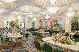 a ballroom with tables and chairs and chandeliers at Helnan Mamoura Hotel & Events Center in Alexandria +48 photos