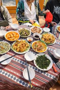 a table with many plates of food on it at PaoDzung Homestay Sapa in Sapa