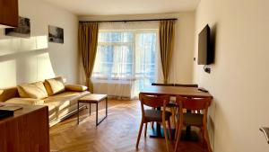 a living room with a couch and a table at Penzion Radost in Poděbrady