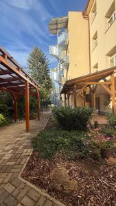 a building with awnings and flowers in front of it at Penzion Radost in Poděbrady