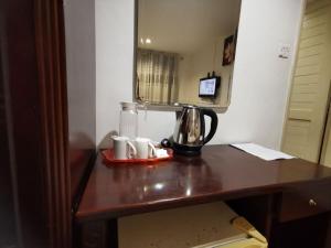 a coffee maker on a table in a room at Watermelon Hotel in Miri