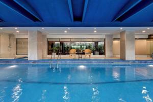 a swimming pool in a house with a blue ceiling at Islamabad Marriott Hotel in Islamabad