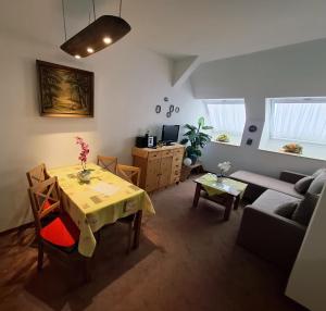 a living room with a table and a couch at Ferienwohnanlage John Alter Stall in Burg