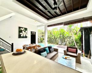 a living room with a couch and a table at Casa Sessy Legian in Seminyak