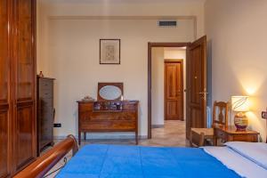 a bedroom with a bed and a dresser and a mirror at ACQUARIO DEI FRALLE in Oristano