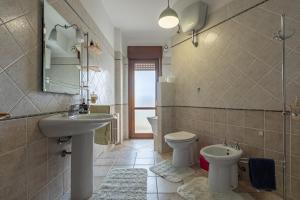 a bathroom with a sink and a toilet at ACQUARIO DEI FRALLE in Oristano +14 photos