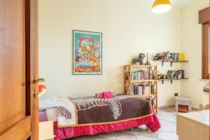 a bedroom with a bed and a book shelf at ACQUARIO DEI FRALLE in Oristano
