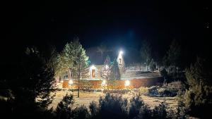 a house lit up at night with lights at Boroviti Mountain House in Blidinje
