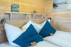 a bed in a room with two pillows on it at Hausboot Baltic Goose in Burgtiefe auf Fehmarn 