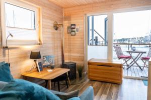 a living room with a couch and a table at Hausboot Baltic Goose in Burgtiefe auf Fehmarn 