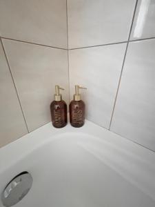 two bottles of soap sitting on top of a bathroom sink at Spacious 3bd Apartment in Lefkakia, Nafplio in Levkákia +14 photos