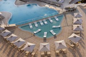 an overhead view of a swimming pool with chairs and umbrellas at Alua Atlantico Golf - All Inclusive in San Miguel de Abona