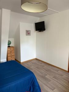 a bedroom with a bed and a flat screen tv at Gîte LA ROUCHERIE bis in Lottinghen +21 photos