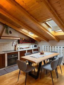 a kitchen with a wooden table and chairs at Bormio Urban Attic in Bormio