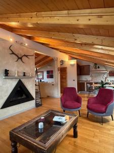 a living room with two chairs and a coffee table at Bormio Urban Attic in Bormio