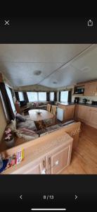 a kitchen and living room with a table and chairs at 162 Northfield, 3 bedroom, 8 berth in Beeford +5 photos