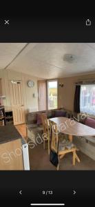 a living room with a table and a couch at 162 Northfield, 3 bedroom, 8 berth in Beeford