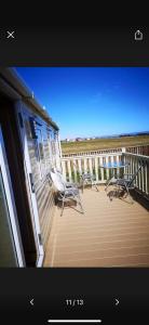a porch with chairs and a balcony with the ocean at 162 Northfield, 3 bedroom, 8 berth in Beeford