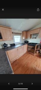 a kitchen with wooden cabinets and a counter top at 162 Northfield, 3 bedroom, 8 berth in Beeford