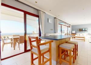a kitchen and dining room with a view of the ocean at Villa Magic Sunset in Kyrenia