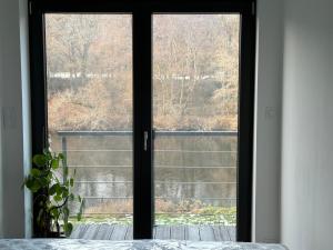 a window in a room with a view of a yard at Studio avec spa vue Moselle in Dinozé
