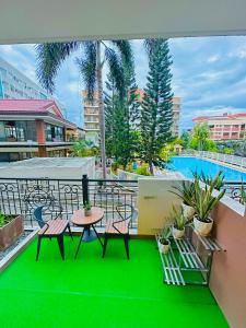 a balcony with a table and chairs and a pool at POOLVIEW 2 bedrooms unit in Davao City +19 photos