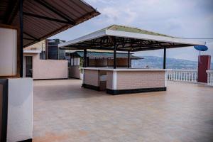 an outdoor bar on a building with a view at Welcome Inn Guest house in Kigali
