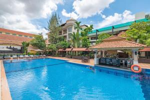 a large swimming pool in front of a building at Somadevi Angkor Premium in Siem Reap