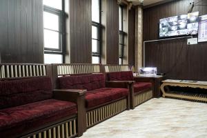 a waiting room with red seats and a screen at Thai Residency - Opp to Bus Stand in Dhārāpuram