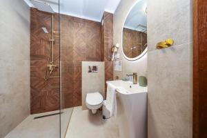 a bathroom with a toilet and a sink and a shower at Branovia in Bran +45 photos
