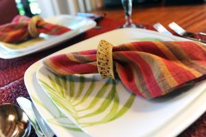 a white plate with a striped scarf on a table at Villa Cayo in San Ignacio
