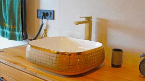 a bathroom with a bowl shaped sink on a counter at Boroviti Mountain House in Blidinje