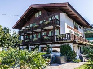 a building with balconies and plants in front of it at Pension Chalet Andy in Schenna