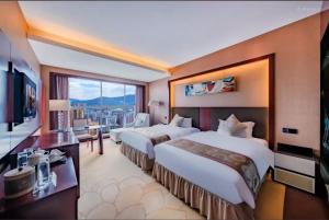 a hotel room with two beds and a large window at Dingyi Hotel in Heilinpu