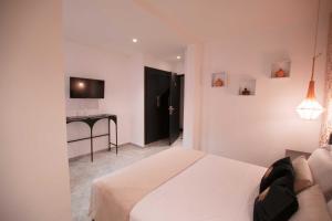a bedroom with a bed and a desk in a room at Riad La Petite Majorelle in Marrakesh