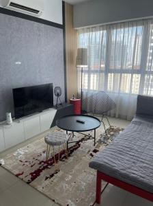 a living room with a couch and a table at Arte Plus Homestay Condo in Kuala Lumpur