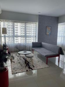 a living room with a couch and a table at Arte Plus Homestay Condo in Kuala Lumpur