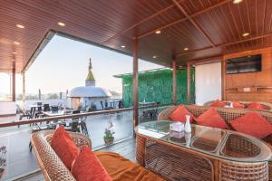 an outdoor patio with wicker chairs and a glass table at Boudha Boutique Hotel in Kathmandu