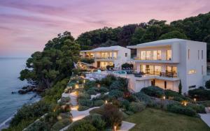 an aerial view of a house on a cliff at Luxury Villas Skiathos in Skiathos