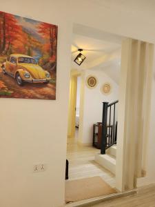 a hallway with a painting of a car on the wall at Olkeleo HummingBird Cottage in Naivasha