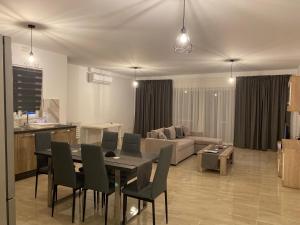a living room with a table and chairs and a couch at Xagħra Lodge in Xagħra