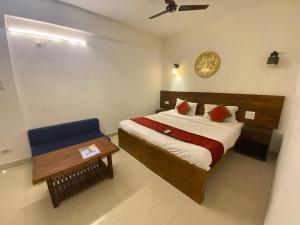 a small bedroom with a bed and a table at The Mamta Courtyard Anjuna in Anjuna +36 photos
