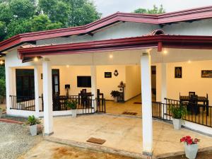 a house with a porch and a patio at Blue Bird Udawalawe in Udawalawe
